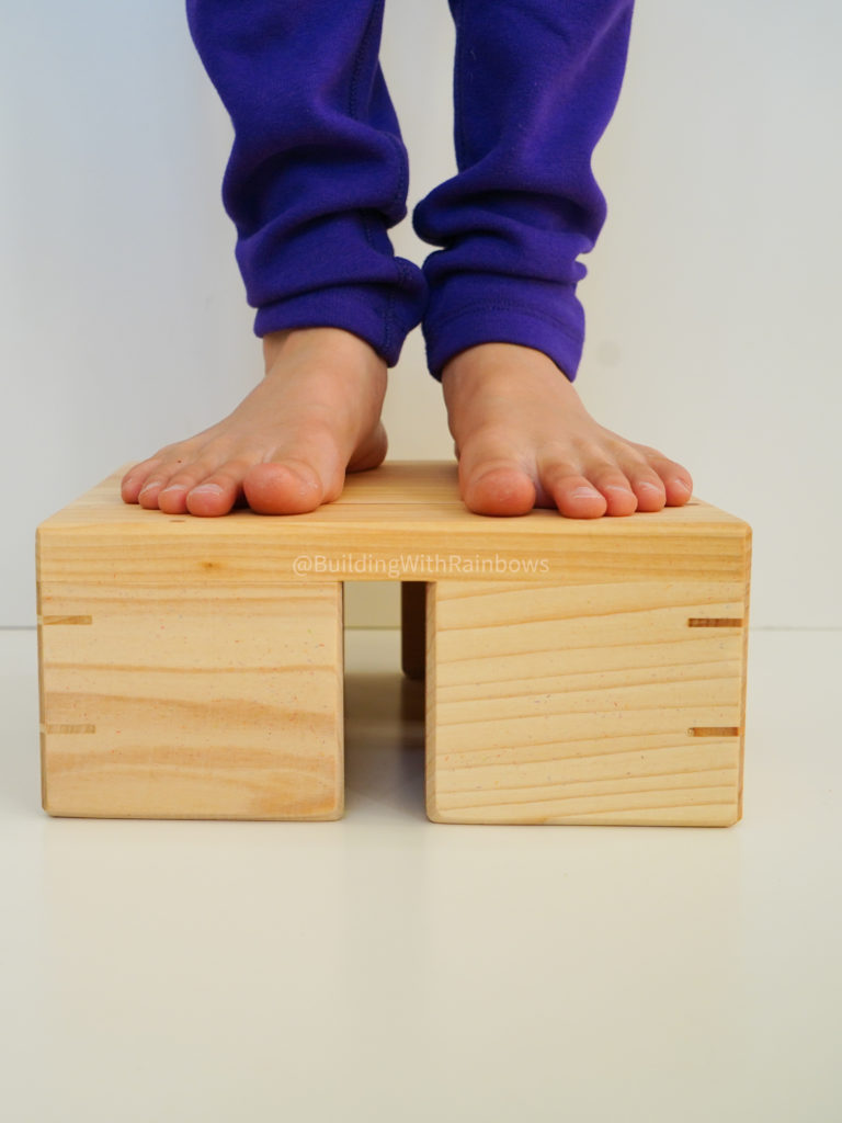 child standing on bauspiel color tile box